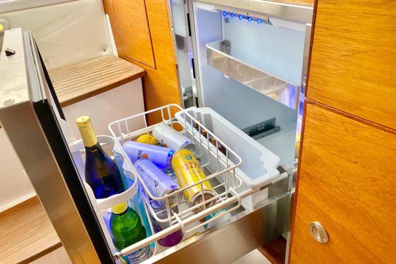 Slide: The Image of Open fridge on 2006 Donzi 38 ZSF boat, stocked with beverages and snacks. - 47