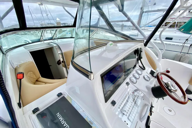 Slide: The Image of 2006 Donzi 38 ZSF boat cockpit with modern navigation equipment and luxurious seating. - 52