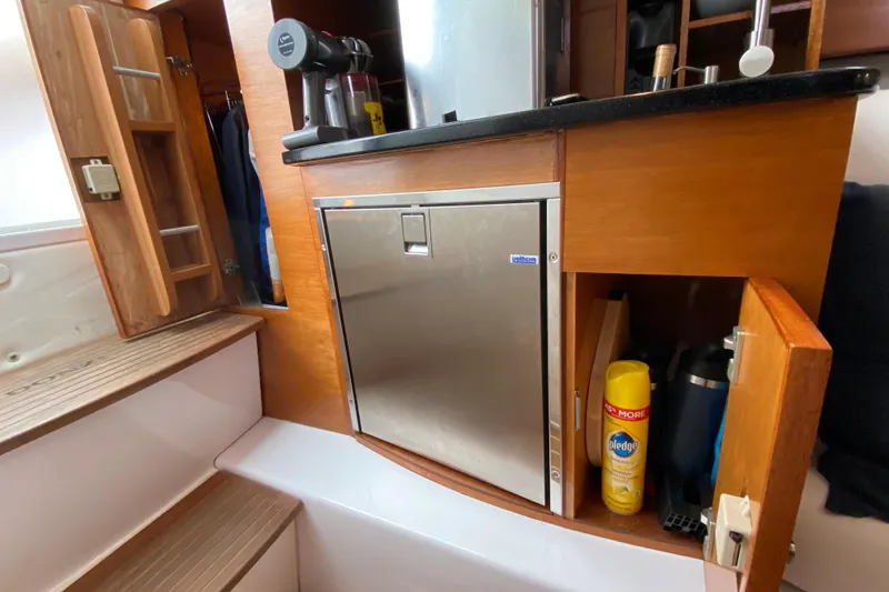 Slide: The Image of 2006 Donzi 38 ZSF cabin interior with fridge and storage cabinets. - 53