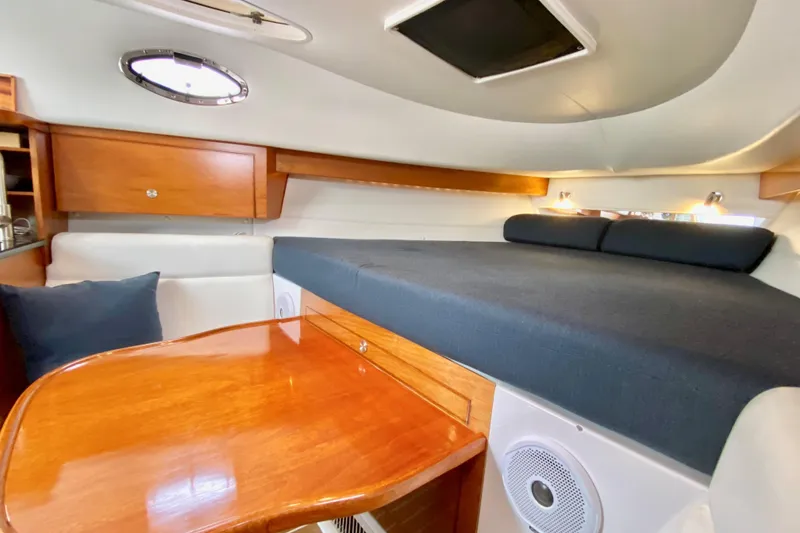 Slide: The Image of Interior cabin of a 2006 Donzi 38 ZSF boat with wood accents and cozy seating. - 54