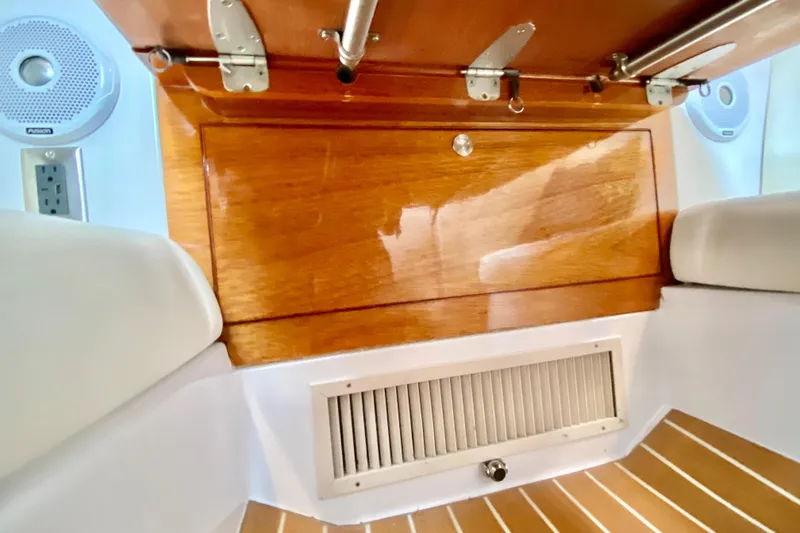 Slide: The Image of Interior view of a 2006 Donzi 38 ZSF boat, featuring wood paneling and speakers. - 55