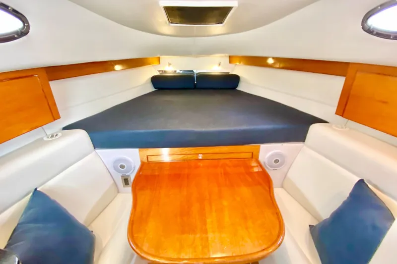 Slide: The Image of Interior cabin of a 2006 Donzi 38 ZSF boat with wood accents and seating. - 56