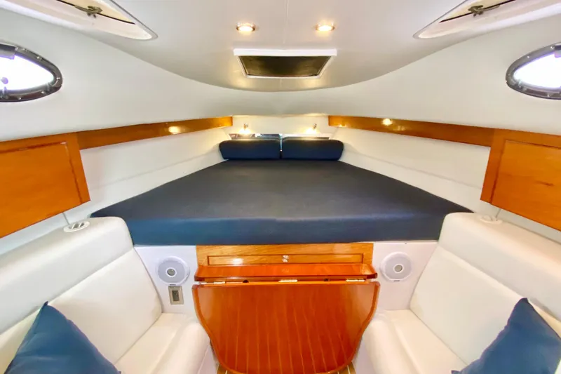 Slide: The Image of Interior of 2006 Donzi 38 ZSF boat with cozy seating and wooden accents. - 57