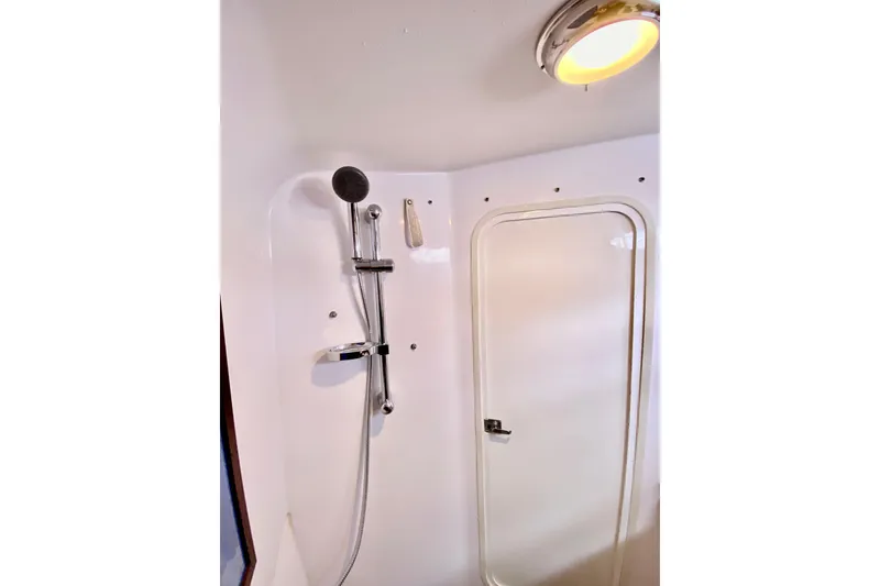 Slide: The Image of Shower area inside 2006 Donzi 38 ZSF boat, featuring modern fixtures and lighting. - 58