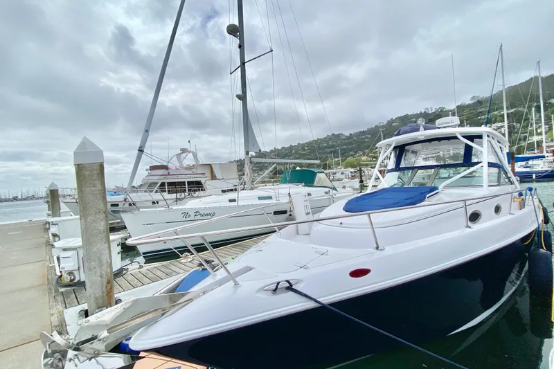 Slide: The Image of 2006 Donzi 38 ZSF boat docked at a marina under cloudy skies. - 6