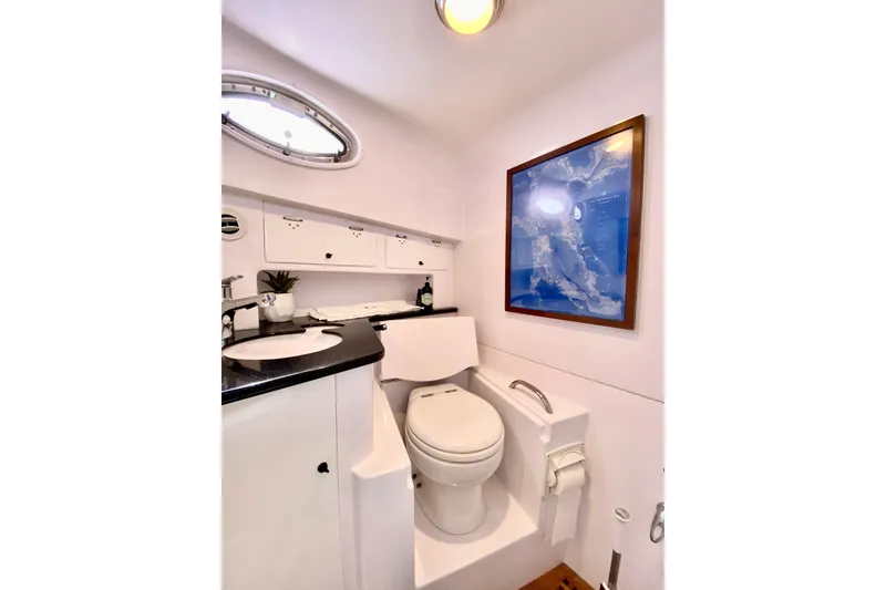 Slide: The Image of Luxurious bathroom interior of 2006 Donzi 38 ZSF boat with modern amenities. - 61