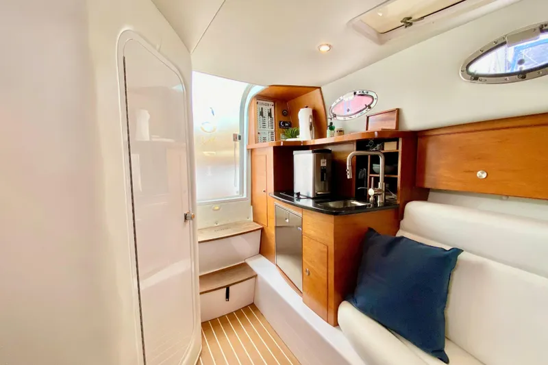 Slide: The Image of Interior of 2006 Donzi 38 ZSF boat with kitchenette and seating area. - 62