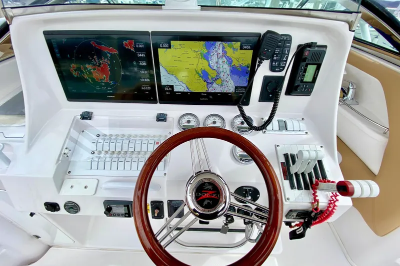Slide: The Image of 2006 Donzi 38 ZSF boat dashboard with navigation screens and controls. - 8