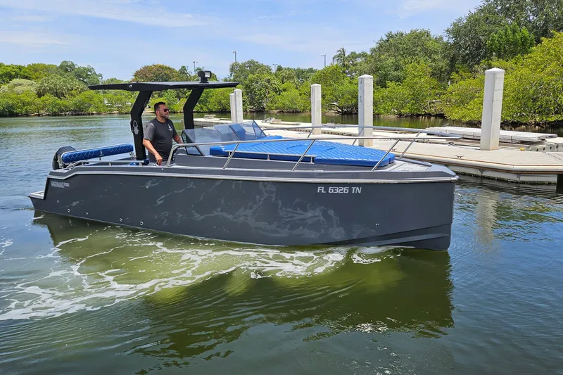 Slide: The Image of 2023 Argonaut 260 boat cruising near a dock, surrounded by lush greenery. - 4