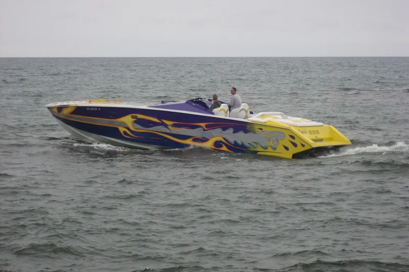 The Image of Colorful 2000 Python Offshore speedboat cruising on open water. - 1