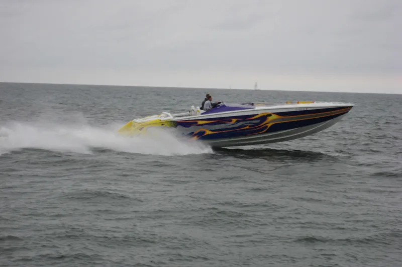 The Image of High-speed Python Offshore boat from 2000 racing on open water. - 2