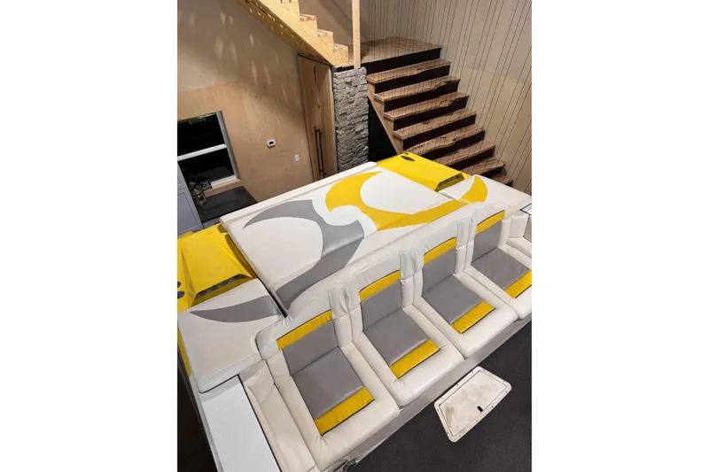 Slide: The Image of Interior of a 2000 Python Offshore boat with stylish yellow and gray seating. - 21