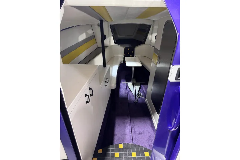 Slide: The Image of Interior of a 2000 Python Offshore boat with modern design and vibrant colors. - 26