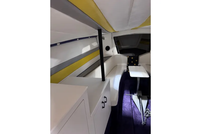 Slide: The Image of Interior of a 2000 Python Offshore boat with modern seating and table. - 27