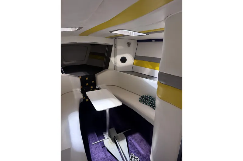 Slide: The Image of Interior of a 2000 Python Offshore boat with modern seating and table. - 28