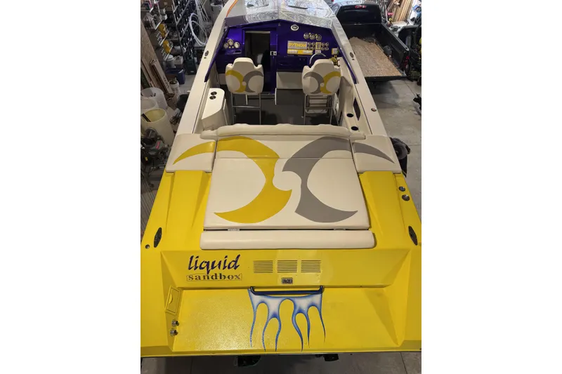 Slide: The Image of Yellow 2000 Python Offshore boat with custom graphics and "liquid sandbox" text on the stern. - 31