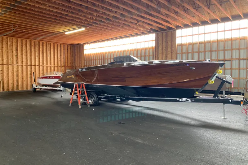 Slide: The Image of 2011 StanCraft 30 Twin Arrow boat in a wooden garage, on a trailer. - 3