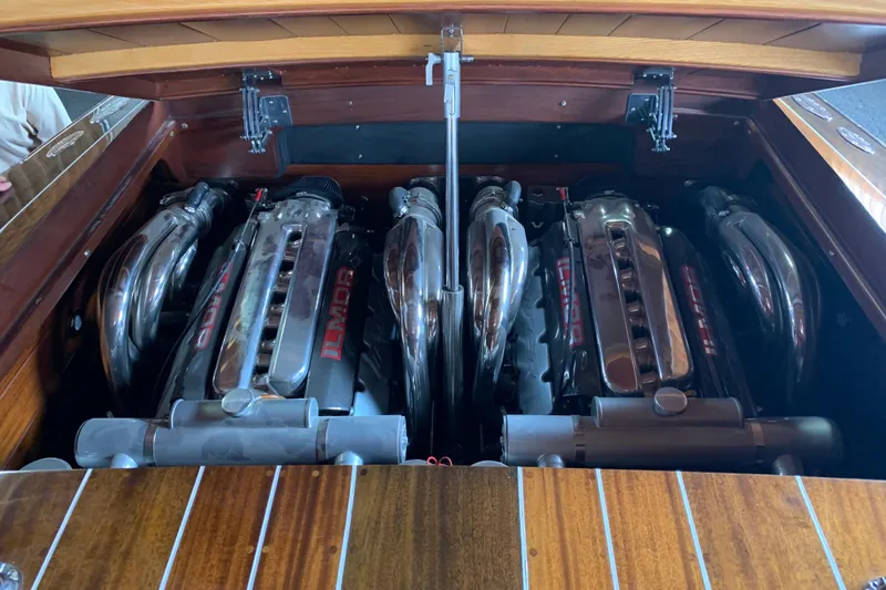 Slide: The Image of Twin engines of a 2011 StanCraft 30 Twin Arrow boat, showcasing polished metal components. - 4