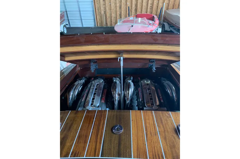 Slide: The Image of 2011 StanCraft 30 Twin Arrow boat engine with polished components in a wooden interior. - 6