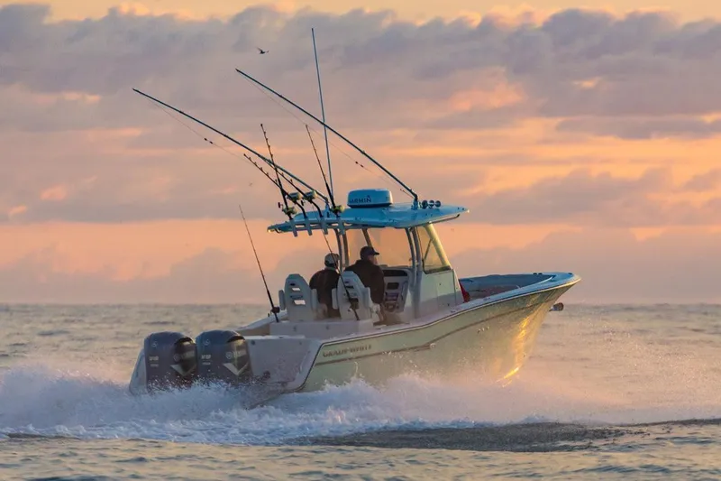 The Image of 2021 Grady-White Canyon 306 boat docked at marina, featuring sleek design and twin engines. - 0