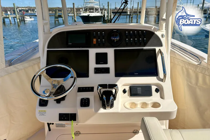 Slide: The Image of Manufacturer Provided Image: 2021 Grady-White Canyon 306 boat interior with white seating and blue cushions. - 10
