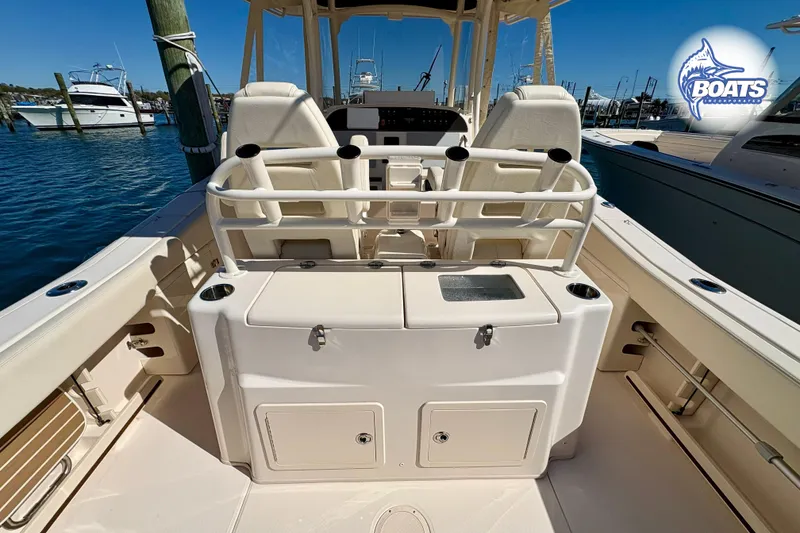 Slide: The Image of 2021 Grady-White Canyon 306 boat helm with modern controls and marina view. - 11