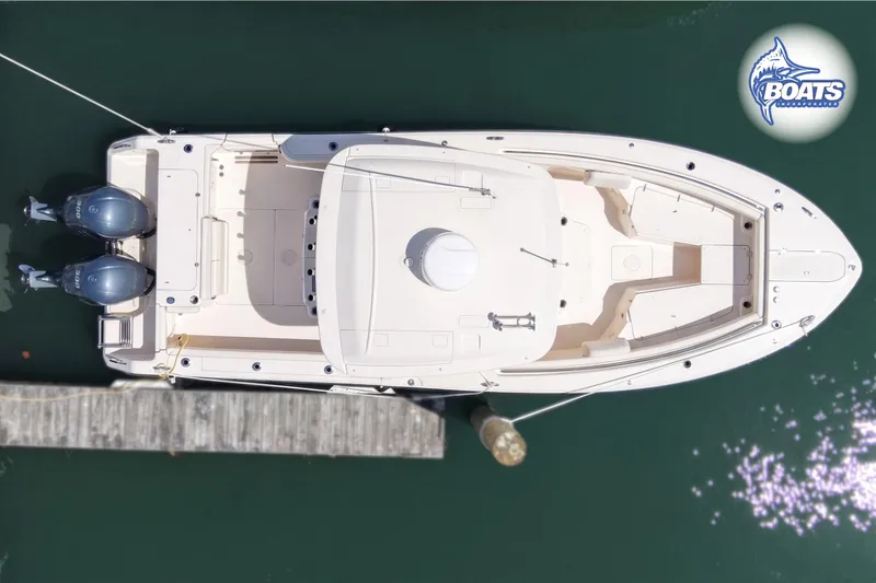 Slide: The Image of 2021 Grady-White Canyon 306 boat with twin Yamaha 300 engines docked at marina. - 19