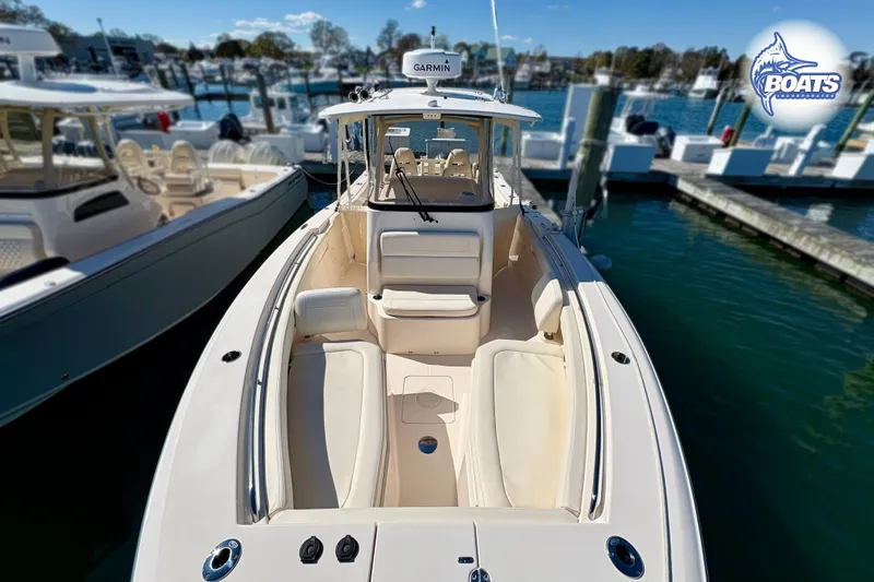 Slide: The Image of 2021 Grady-White Canyon 306 boat docked at marina, side view. - 2