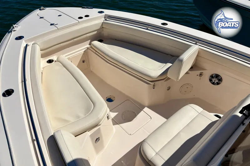 Slide: The Image of 2021 Grady-White Canyon 306 boat docked in a marina, showcasing spacious seating. - 4