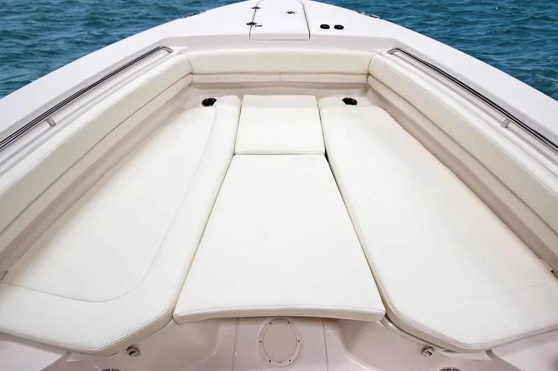 Slide: The Image of 2021 Grady-White Canyon 306 boat interior with cushioned seating and storage compartments. - 6