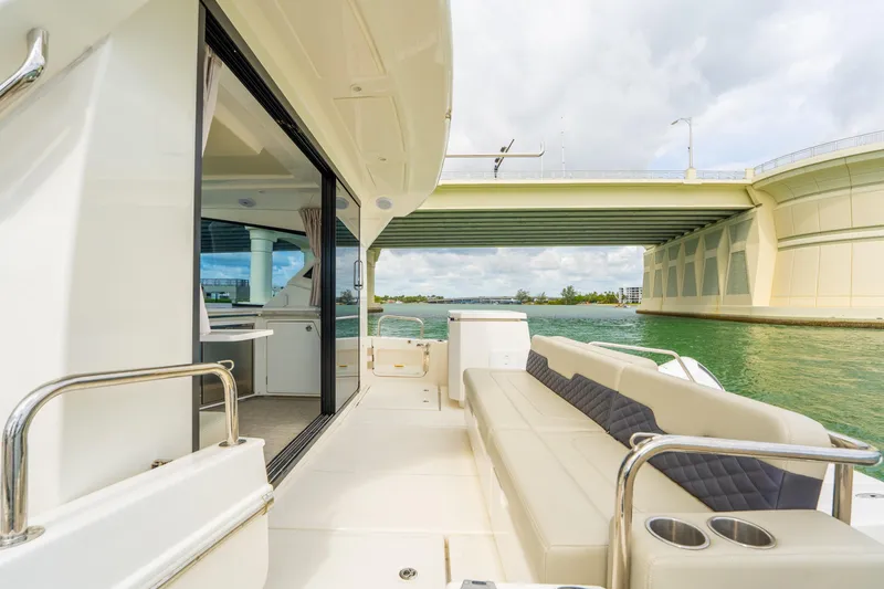 Slide: The Image of 2025 Aquila 36 Cruiser yacht with spacious deck, under a bridge, on a sunny day. - 10