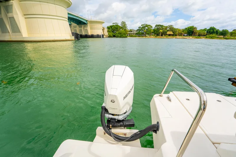 Slide: The Image of Aquila 36 Cruiser 2025 with Mercury outboard motor near a bridge on calm water. - 13