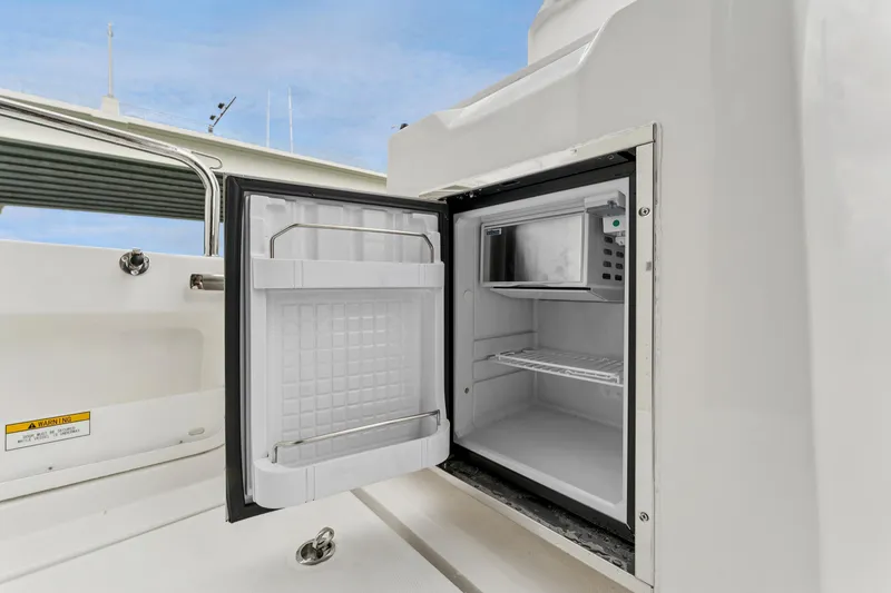 Slide: The Image of Open refrigerator on 2025 Aquila 36 Cruiser yacht, showcasing interior storage space. - 17