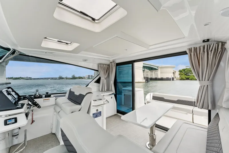 Slide: The Image of Interior of 2025 Aquila 36 Cruiser yacht with modern seating and panoramic windows. - 18