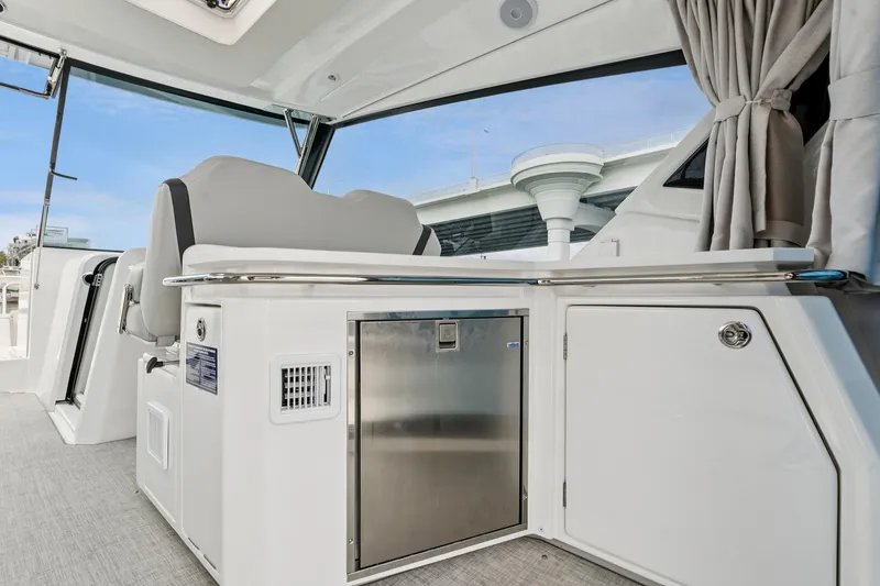 Slide: The Image of Interior of 2025 Aquila 36 Cruiser, featuring sleek seating and modern cabinetry. - 22