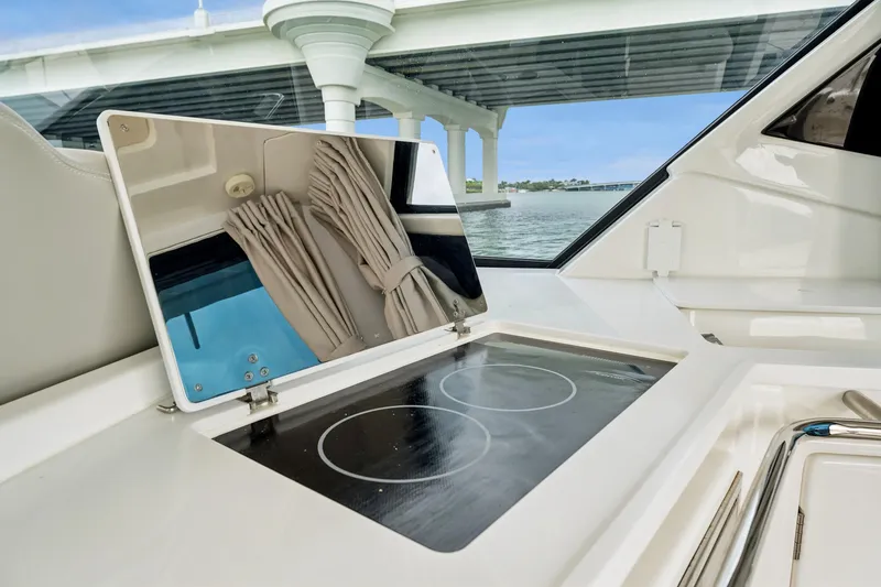 Slide: The Image of Modern kitchen area on 2025 Aquila 36 Cruiser yacht with induction cooktop and scenic view. - 24