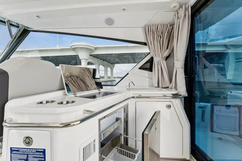 Slide: The Image of Interior of 2025 Aquila 36 Cruiser featuring a modern kitchenette with sleek design. - 25