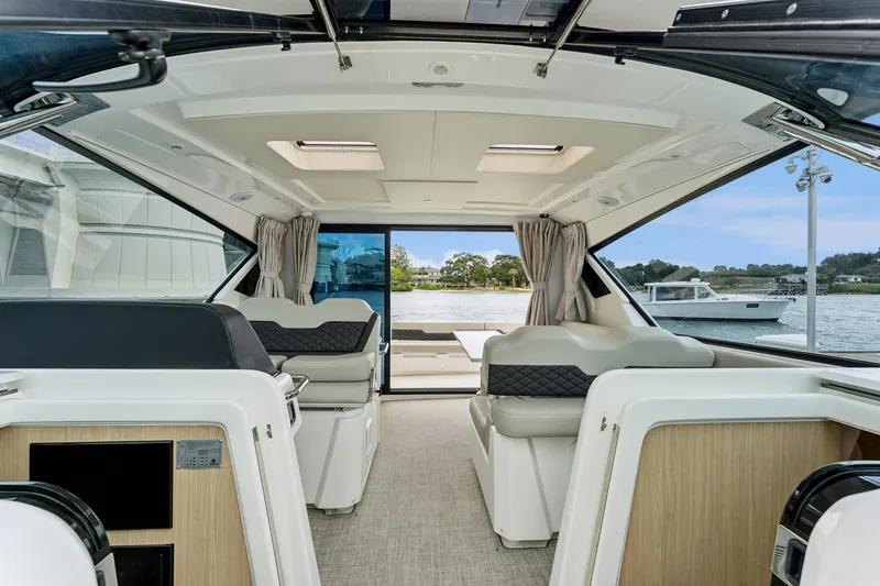 Slide: The Image of Interior of 2025 Aquila 36 Cruiser yacht with modern seating and panoramic windows. - 26