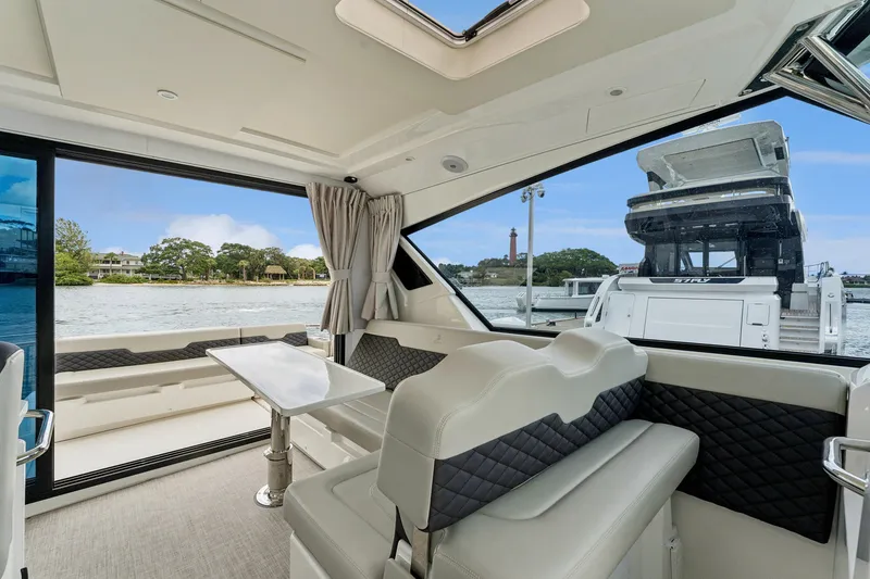 Slide: The Image of Interior of 2025 Aquila 36 Cruiser yacht with elegant seating and scenic water view. - 27