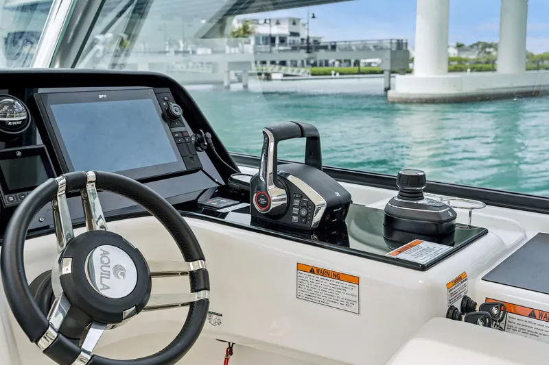 Slide: The Image of Helm of 2025 Aquila 36 Cruiser with modern controls and navigation system. - 31