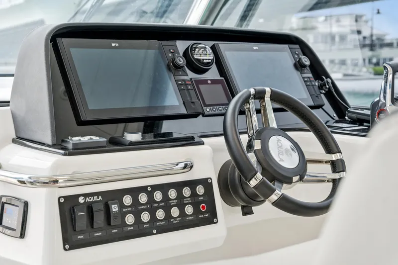 Slide: The Image of Helm of 2025 Aquila 36 Cruiser featuring modern controls and dual displays. - 32