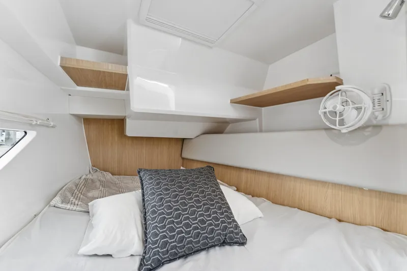 Slide: The Image of Cozy cabin interior of 2025 Aquila 36 Cruiser with pillows and wooden accents. - 35