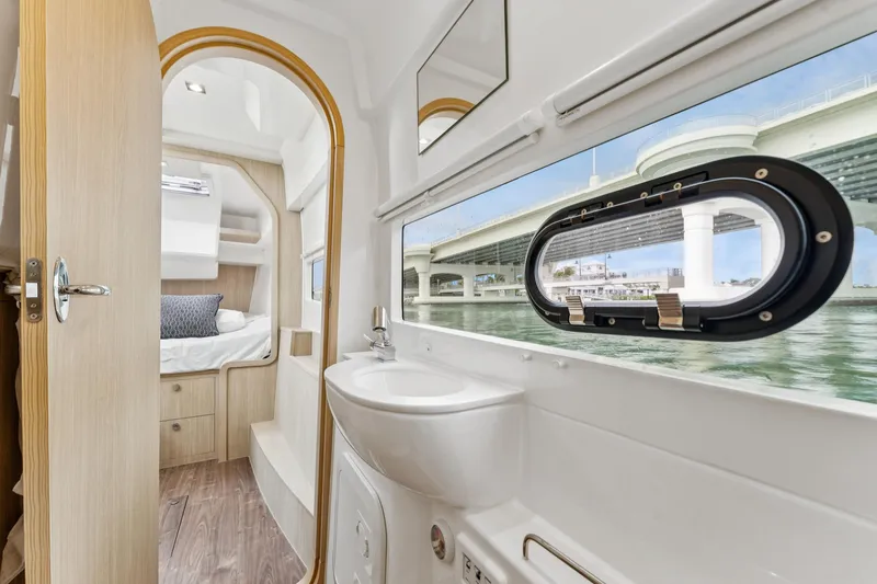 Slide: The Image of Interior of 2025 Aquila 36 Cruiser, featuring a cozy cabin and modern bathroom with scenic window view. - 41