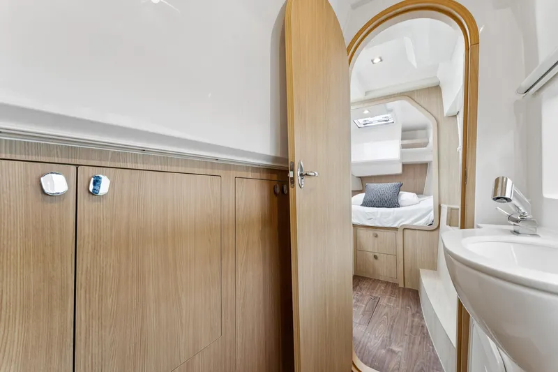 Slide: The Image of Interior of 2025 Aquila 36 Cruiser, featuring a cozy cabin and modern bathroom. - 42