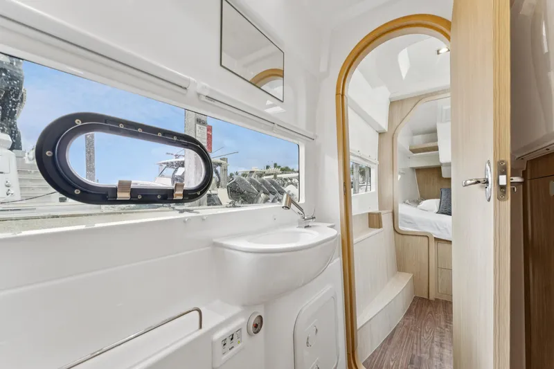 Slide: The Image of Interior of 2025 Aquila 36 Cruiser, featuring modern bathroom and cozy sleeping area. - 44