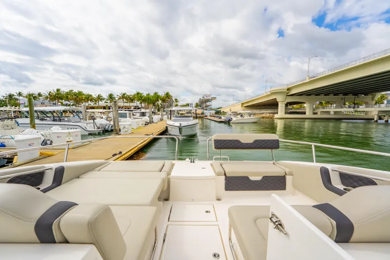 Slide: The Image of Aquila 36 Cruiser 2025 docked at marina with bridge and palm trees. - 45