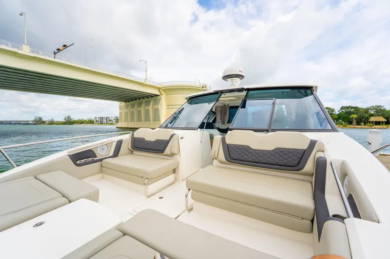Slide: The Image of 2025 Aquila 36 Cruiser yacht with luxurious seating, cruising under a bridge on a sunny day. - 49