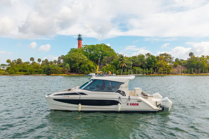 Slide: The Image of Aquila 36 Cruiser 2025 on water near lush greenery and lighthouse. - 51