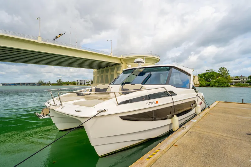 Slide: The Image of 2025 Aquila 36 Cruiser docked near a bridge on a cloudy day. - 55