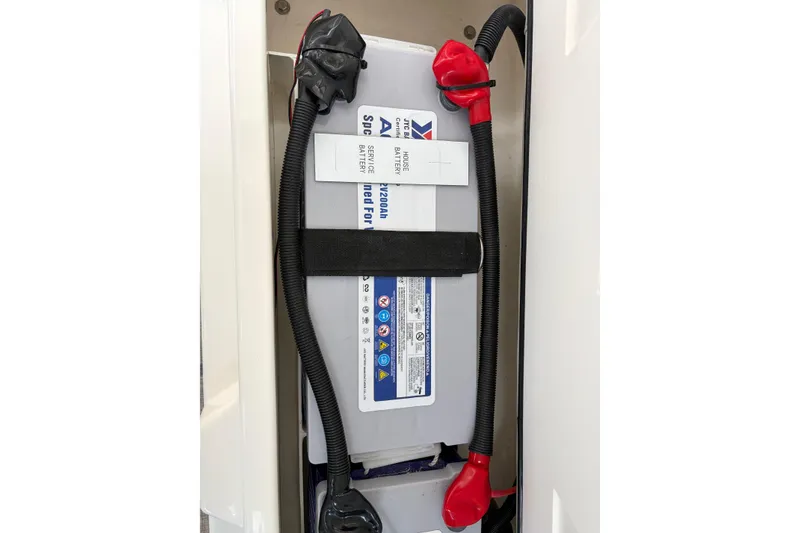 Slide: The Image of Battery compartment of 2025 Aquila 36 Cruiser with secured cables and labels. - 56